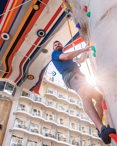 A climber on the ship's outdoor rock wall