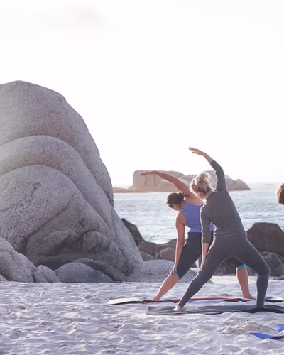 A yoga class on the beach at a port of call