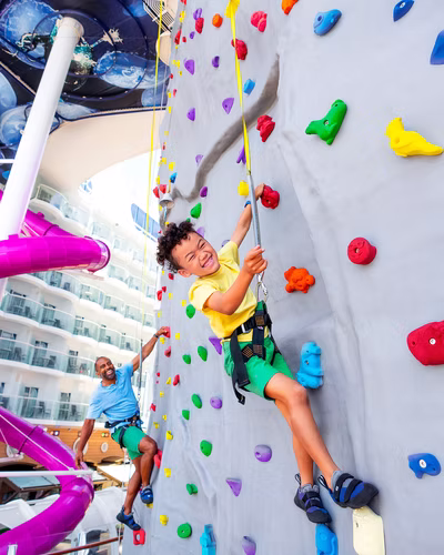 A child climbing the on-board rock wall