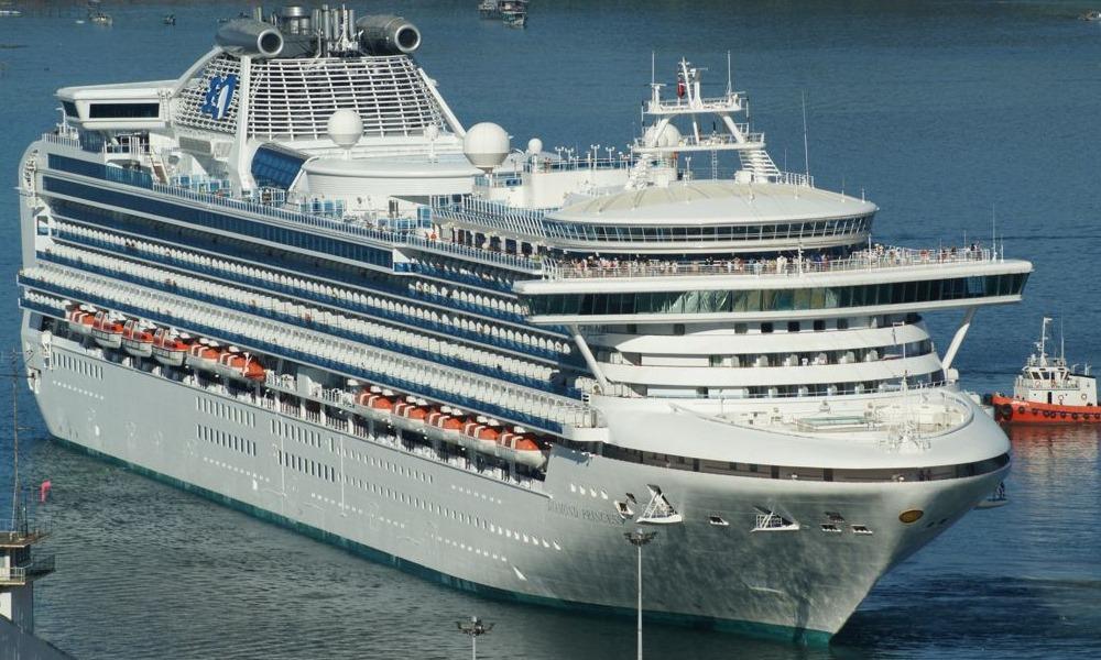 Diamond Princess alongside in port, a tug at her stern