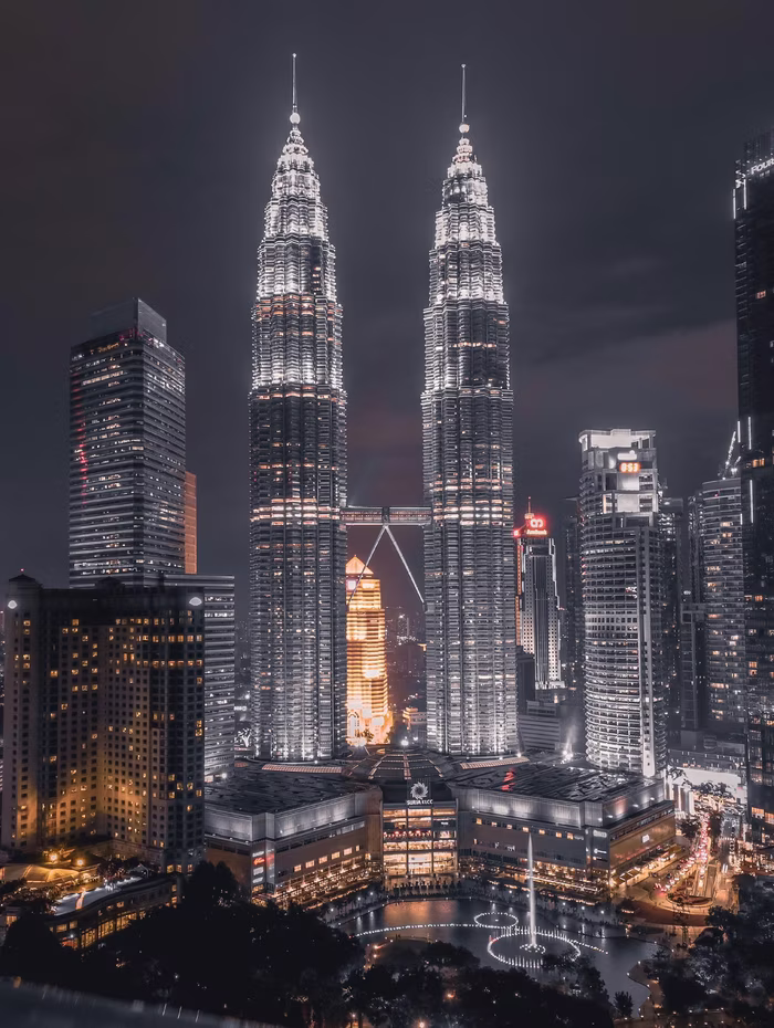 The Petronas Towers lit up over Kuala Lumpur at night
