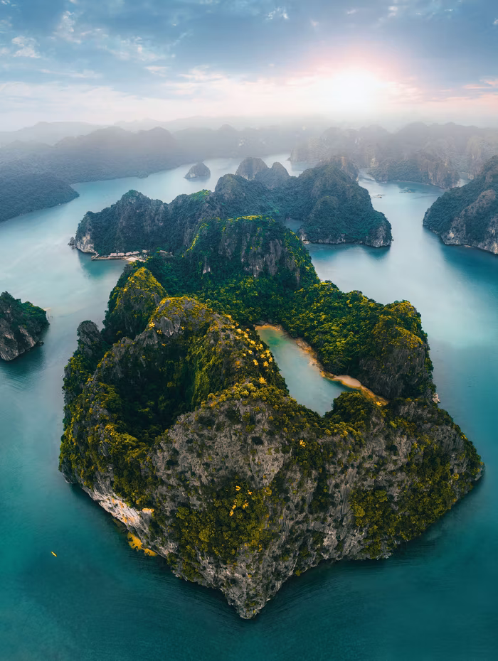 Limestone karst islands rising from Ha Long Bay at dawn